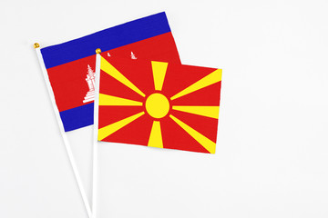 Macedonia and Cambodia stick flags on white background. High quality fabric, miniature national...