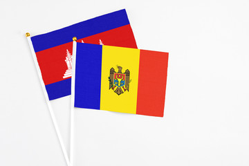 Moldova and Cambodia stick flags on white background. High quality fabric, miniature national flag. Peaceful global concept.White floor for copy space.
