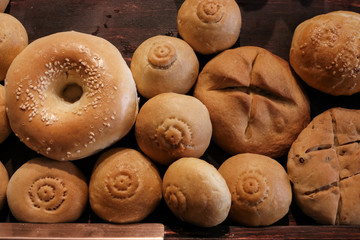 Various kinds of Naan. Famous homemade bread originated from Muslim country. Assorts fresh home made bread on wooden table under warm light.