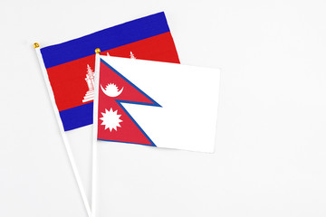 Nepal and Cambodia stick flags on white background. High quality fabric, miniature national flag....