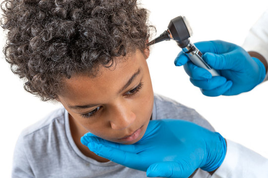 Otoscope Examination: Physician performing ear examination during a visit