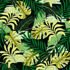 Fashionable seamless tropical pattern with bright green and yellow plants and leaves on black background.  Vector design. Jungle print. Floral background.  Exotic tropics. Summer.