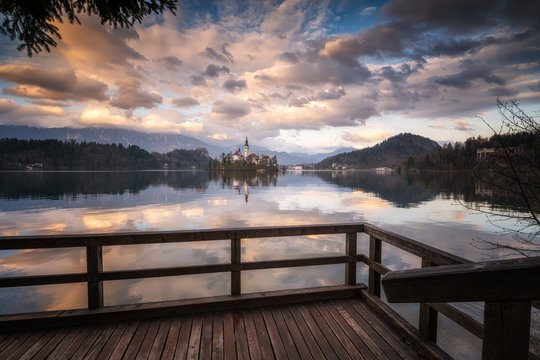 Amazing colorful view of Bled lake with St. Marys Church of the Assumption on the small island and mountains in the background at sunset