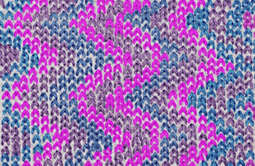 background pattern of knitted pattern of threads of different colors for winter things