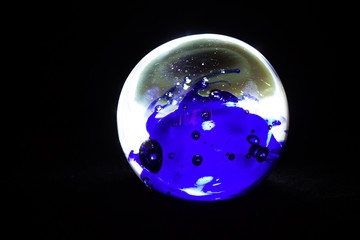 Christmas ball on a black background, planet in space