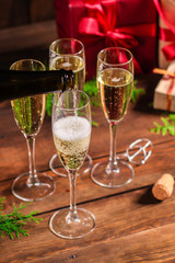 champagne in transparent glasses and a bottle, happy holidays! gifts and holiday, happy New Year, Christmas. festive food background. top view. copy space