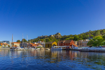 Fototapeta na wymiar Halden waterfront during sunny, summer day with the Fredriksten fortress as the backdrop. Ostfold County, Norway.