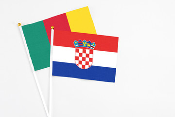Naklejka premium Croatia and Cameroon stick flags on white background. High quality fabric, miniature national flag. Peaceful global concept.White floor for copy space.