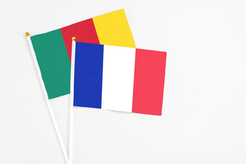 France and Cameroon stick flags on white background. High quality fabric, miniature national flag. Peaceful global concept.White floor for copy space.