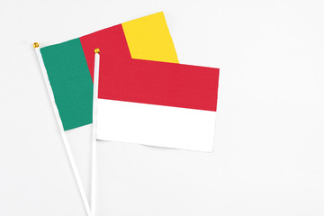 Indonesia and Cameroon stick flags on white background. High quality fabric, miniature national flag. Peaceful global concept.White floor for copy space.