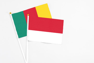 Monaco and Cameroon stick flags on white background. High quality fabric, miniature national flag. Peaceful global concept.White floor for copy space.