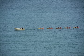 a boat towing several boats with tourists on the ocean in Lagos city - Portugal 31.Oct.2019