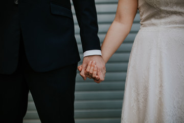 bride and groom holding hands