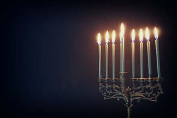 Fototapeta premium Religion image of jewish holiday Hanukkah background with menorah (traditional candelabra) and candles