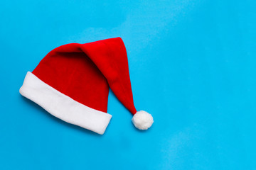 santa hat isolated on blue background with copy-space.