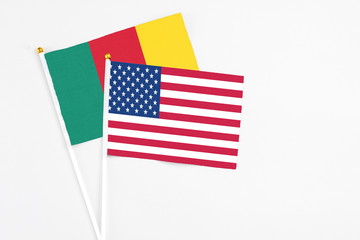 United States and Cameroon stick flags on white background. High quality fabric, miniature national flag. Peaceful global concept.White floor for copy space.