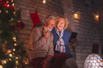 Senior couple having a video call with family on Christmas Eve