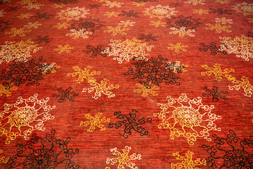 Circular flower shaped designs on a floor mat or carpet