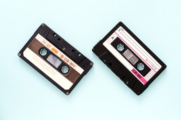 Fototapeta premium Two vintage audio tapes on a light blue background close-up. Top view