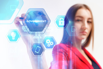 Business, Technology, Internet and network concept. Young businessman working on a virtual screen of the future and sees the inscription: Government © photon_photo