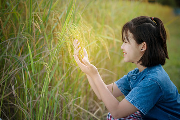 girl farmer holding  paddy rice in rice field