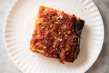 Grandma pizza slice on a paper plate