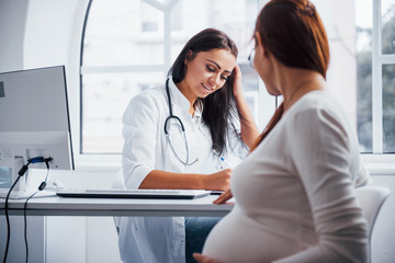 Pregnant woman have consultation with obstetrician indoors