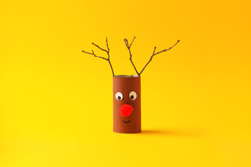 Paper toy reindeer for Happy new year Merry Christmas party. Easy crafts for kids on yellow...