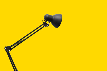Desk lamp on yellow background. Creative concept.