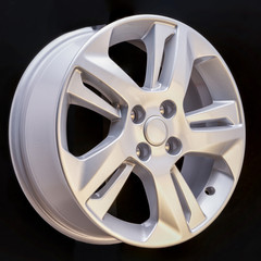 Obraz premium Alloy rim on black background, alloy wheels closeup. The elements spokes