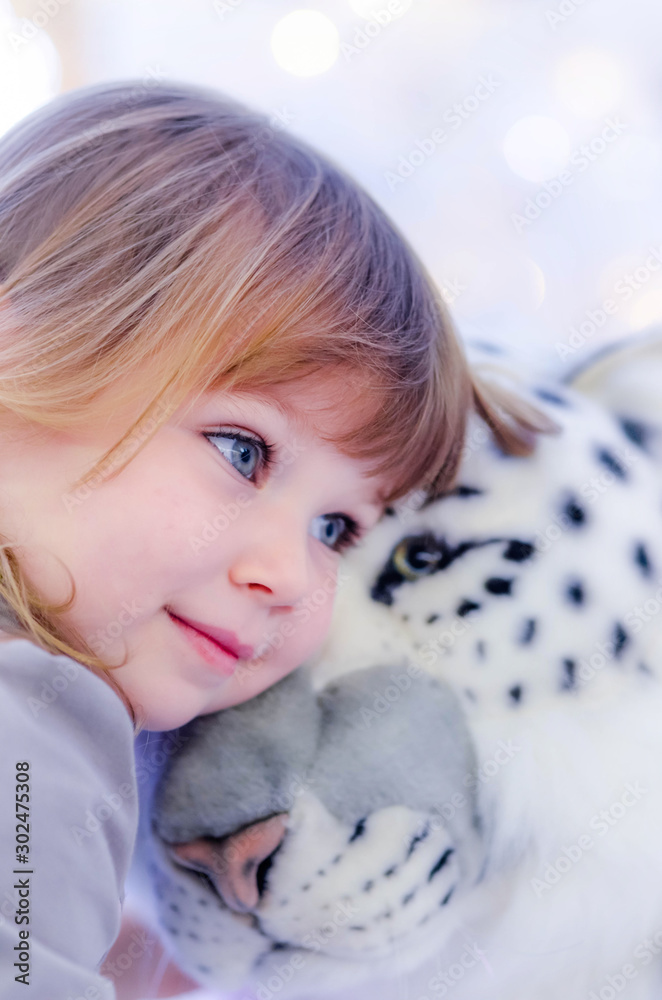 Poster pretty little girl hugging her cuddly toy