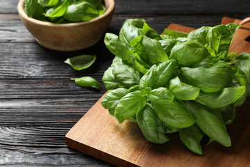 Fresh green basil on black wooden table, closeup