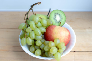 Mixed fruit in white plate isolated on white background - Healthy food style.