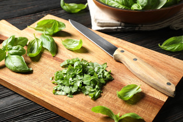 Fresh green basil on black wooden table