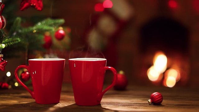 Christmas Decorations and Red Cups of Coffee on Fireplace Background. Holiday Background