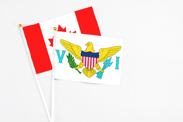 United States Virgin Islands and Canada stick flags on white background. High quality fabric, miniature national flag. Peaceful global concept.White floor for copy space.