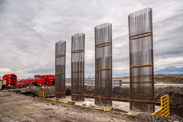 Reinforcing frames of bridge supports on the background of red formwork