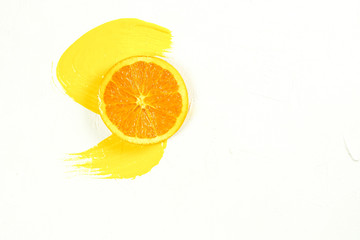 Sliced orange and orange juice spreading on a white background - clipping path