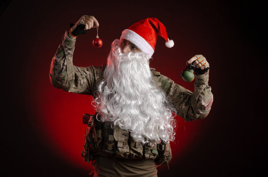 a man in a military uniform with a gun and a Santa Claus hat
