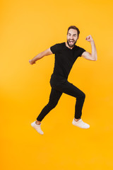 Full length image of caucasian man in basic clothes smiling and running