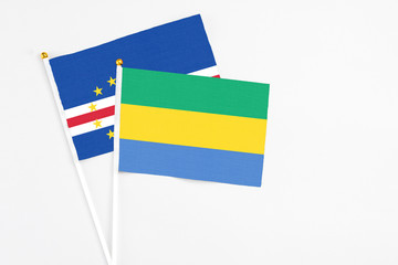 Gabon and Cape Verde stick flags on white background. High quality fabric, miniature national flag. Peaceful global concept.White floor for copy space.