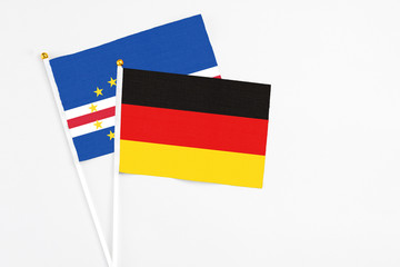 Germany and Cape Verde stick flags on white background. High quality fabric, miniature national flag. Peaceful global concept.White floor for copy space.