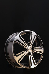 Alloy rim on black background, alloy wheels closeup. The elements spokes