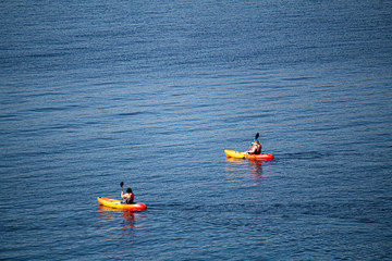 red and yellow kayaks on the lake