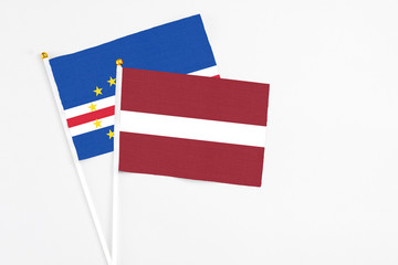 Latvia and Cape Verde stick flags on white background. High quality fabric, miniature national flag. Peaceful global concept.White floor for copy space.
