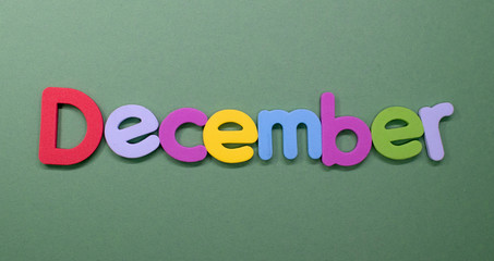 Word "December" written with color sponge