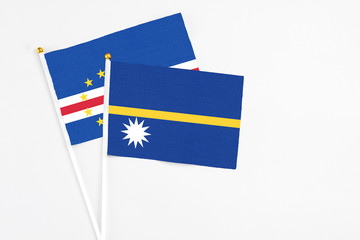 Nauru and Cape Verde stick flags on white background. High quality fabric, miniature national flag. Peaceful global concept.White floor for copy space.