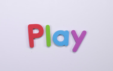 Word "Play" written with color sponge