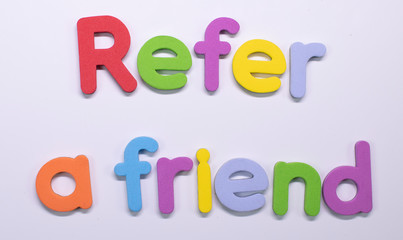 "Refer a friend" written with color sponge