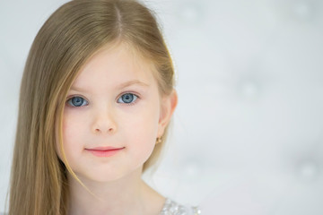 Portrait of a beautiful baby girl. The face of a five year old child. Small model
